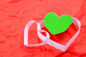 Paper hearts on red background photo