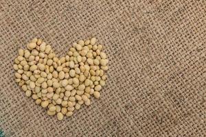 soy bean in heart shape on sack background. photo