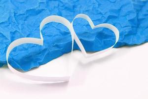 Paper hearts on blue background photo