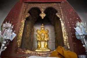 close up Buddha statue gilded in the measure photo