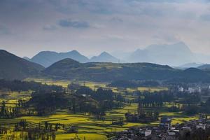 Spring fresh landscape of colorful fields, sunrise sky and beautiful hills valley photo