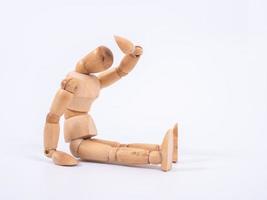 The wooden dummy sits on white background photo