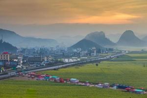 Yellow rapeseed flower field with the mist in Luoping, China photo