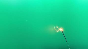 Lightening sparkler on the green background. Sparkler concept. video