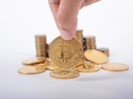 Man's hand put money coins to stack of  cryptocurrency. Money, Financial, Business Growth concept photo