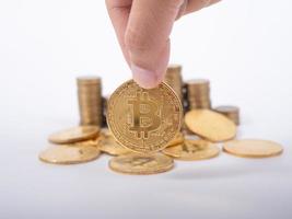 Man's hand put money coins to stack of  cryptocurrency. Money, Financial, Business Growth concept photo