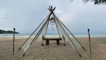 Sunrise at tropical beach with chairs and hut. video