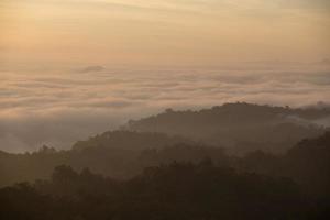 Fog mountain in the early morning sunrise photo