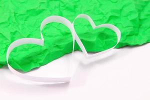 Paper hearts on green background photo