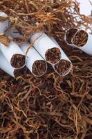 Tobacco pile and cigarettes photo