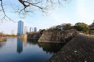 A moat surrounding Osaka castle in Japan, winter photo