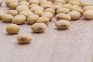 Soy beans on wood background photo