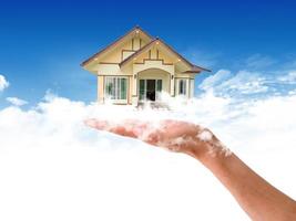 The House in the hands against the blue sky photo