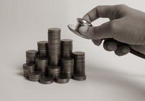 Stethoscope on coin stack, on white background. money for health care, Financial Aid, concept photo