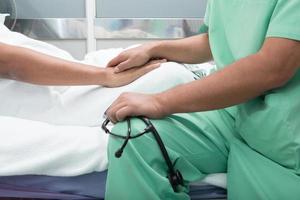 medical doctor holing senior patient's hands photo