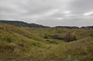 Heavy Clouds Over a Grass Covered Valley photo