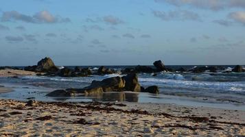 Large Rocks Jutting Into the Ocean in Aruba photo