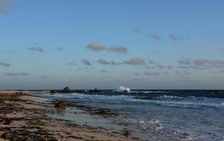 Waves Crashing on the Rocks in the Ocean photo