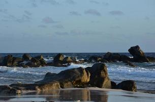 Rocks with Ocean Waves Crashing and Surrounding Them photo