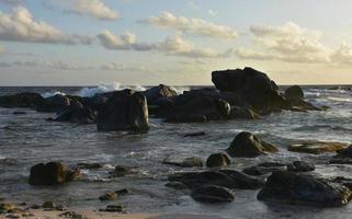 Waves Crashing at Dawn on Rocks in the Ocean photo