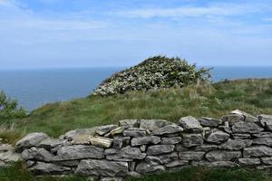 Stone Wall Lining the Sea Cliff in England photo