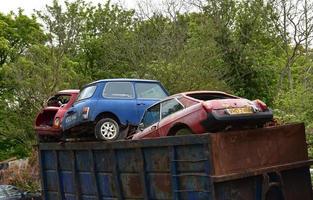Cars Over Flowing in a Trash Dumpster in England photo