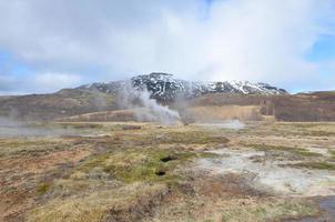 Hot spring geysir with a beautiful scenic landscape photo