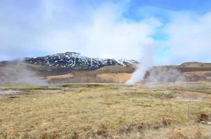 Beautiful blue skies with steaming hot springs in Iceland photo