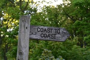 Wood Coast to Coast Sign Post Directing Walkers photo