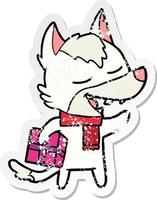 distressed sticker of a cartoon wolf with christmas present laughing vector