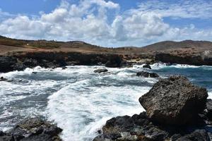 Waves Crashing Ashore on the Black Stone Beach photo