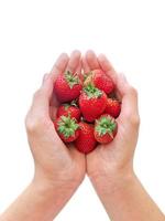 healthy eating, dieting, vegetarian food and people concept - close up of woman hands holding strawberries at home photo