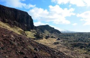 Rugged Lava Rock Landscape with Mountains in the Distance photo