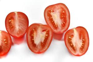 Sliced red tomato on a white background photo