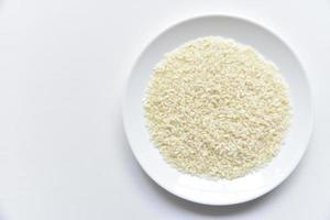 White rice on a white plate on a white background. photo