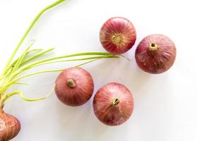 Thai red onion or Shallots. Fresh purple shallots on white background. Selected focus. Concept of spices in healthy cooking photo