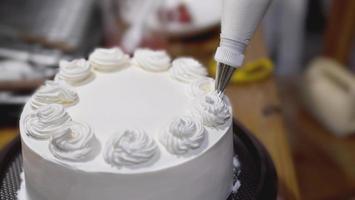 Lady making cream cake - people with homemade bakery concept photo