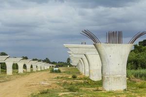 Construction and casting of concrete columns to support the weight of the expressway bridge - under construction to support the bridge structure controlled by civil engineers to reduce travel photo