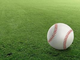 Baseball on the clear green grass turf close-up as macro shot with copy space on the left and top photo