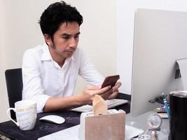 Male architect working with laptop in the office photo