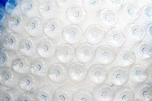 rows of empty plastic bottles at bottling plant photo