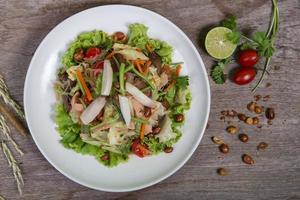 Thai salad with carrot, tomato, glass noodle, celery and pork photo