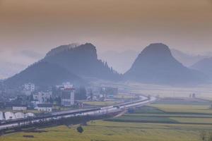 Yellow rapeseed flower field with the mist in Luoping, China photo