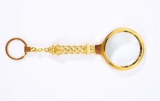 Small Gold Magnifying Glass Isolated on a White Background. photo