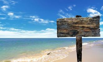 cartel de madera en la playa y el mar foto