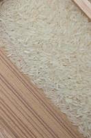 rice grain and wooden background texture photo