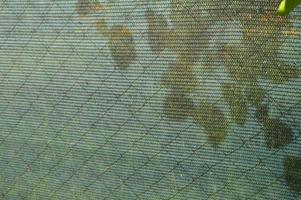 Installation of a shading net on a chain-link fence photo