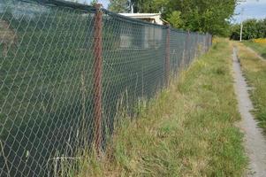 Installation of a shading net on a chain-link fence photo