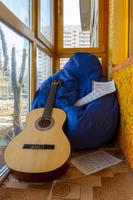 Composition with guitar and sheet music on balcony photo