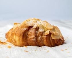 Fresh croissants bread and a cup of coffee on fabric. photo